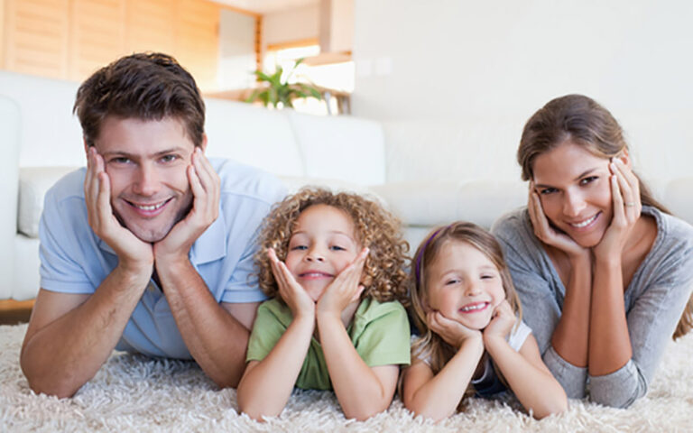 happy family lying on carpet