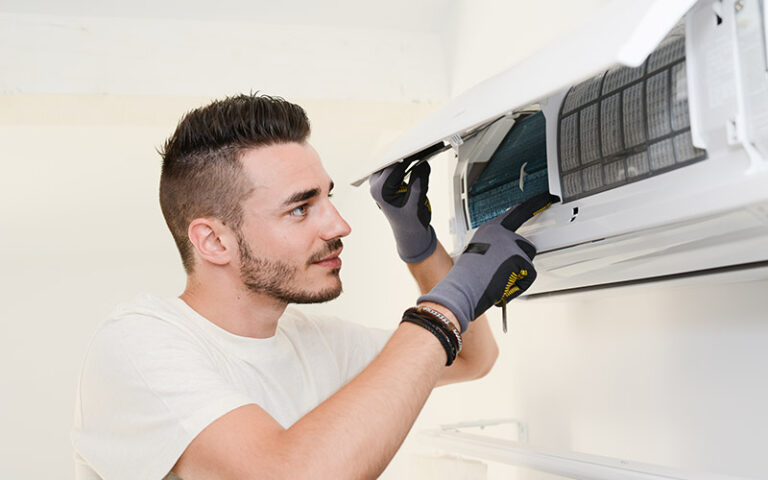 technician repairing ductless air conditioner